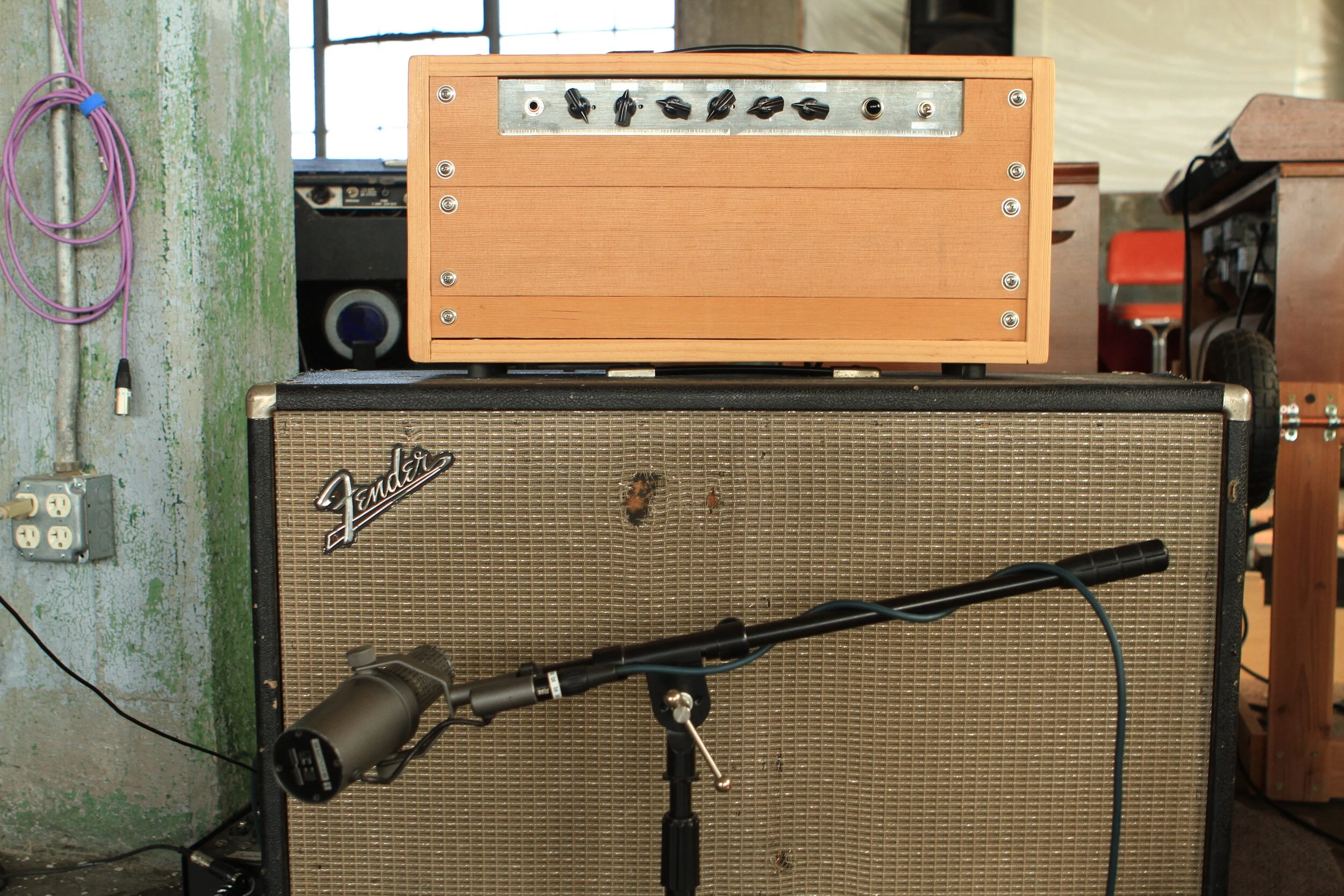 An original early Shure SM7 (Made in USA) on a 2x12 Bassman Speaker cab.  These original SM7 microphones have square holes in the grill and are different in use than the later SM7B microphones. The cab is loaded with a pair of Jensen Blackbird Alnic