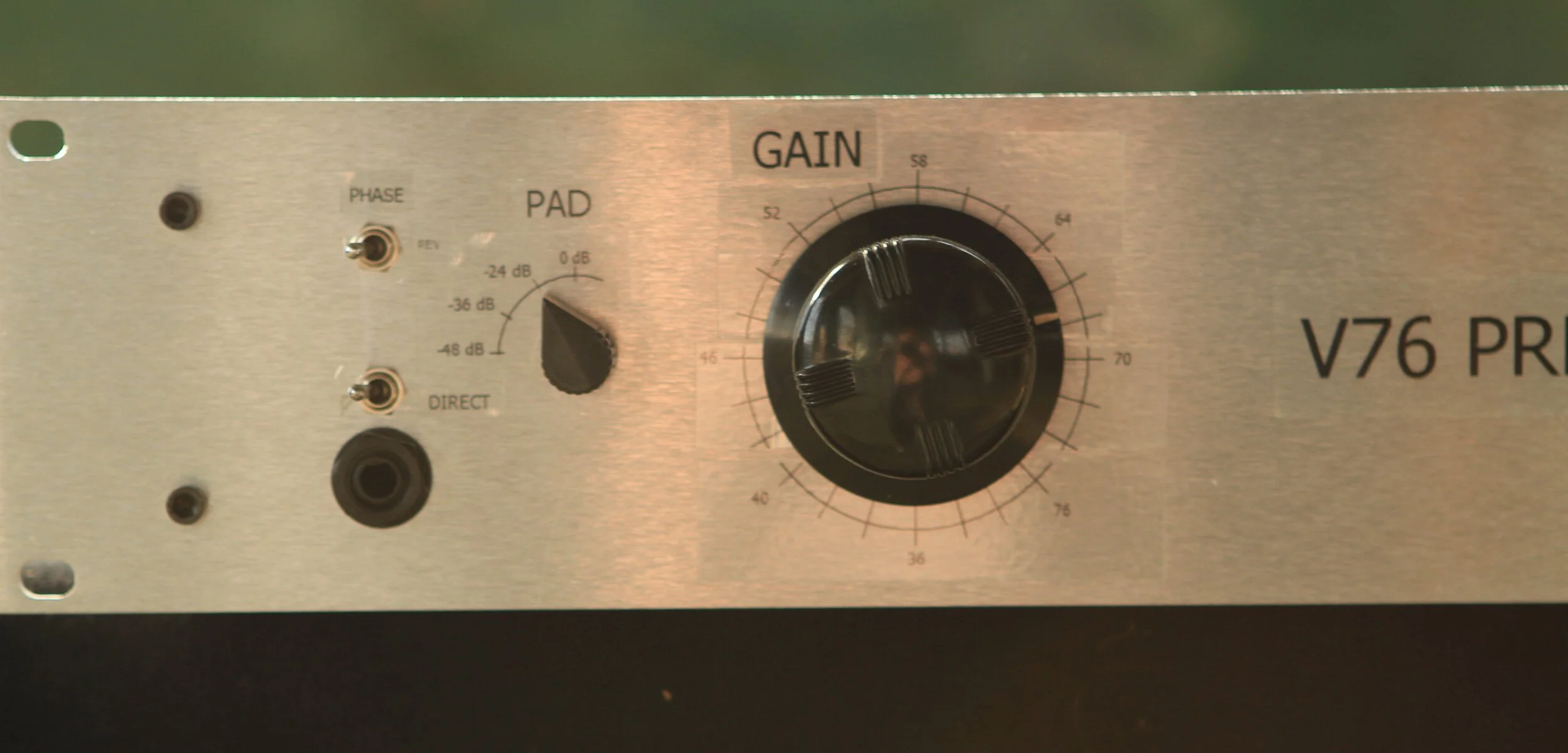 This V76 microphone preamplifier has up to 76 dB of gain. The original design combined a input pad with a gain switch, but this lacks flexibility and would not work well with a DI. This build splits the pad to a separate switch (matching the origina